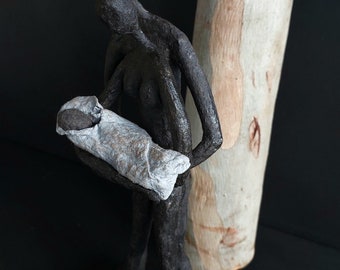 Mother, father and newborn baby sculpture