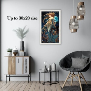 May include: A framed print of a woman in a blue dress standing in a field of stars. The woman is holding a blue orb in her hand. The print is surrounded by a white frame.