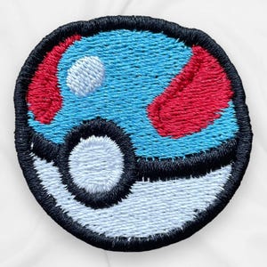 May include: Embroidered patch featuring a blue and red design with a white circle and a black border. The patch is round and has a textured appearance, resembling a stylized ball. The patch is likely for clothing or accessories.