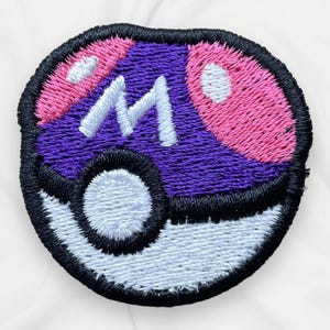 May include: Purple and pink embroidered patch with a white letter M in the centre, resembling a Poké Ball.