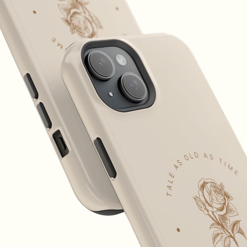 May include: A beige iPhone case with a rose and the text "Tale as old as time" printed on it.