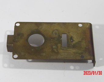 Brass plate 1 3/4" x 3 1/4 with four mounting holes and a roller bearing at one end.