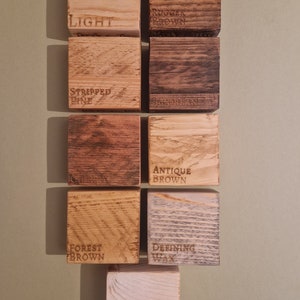 May include: Nine wood samples with different finishes, labeled "Light", "Rugged Brown", "Stripped Pine", "Jacobean", "Cherry", "Antique Brown", "Forest Brown", "Defining Wax", and "White Wax".