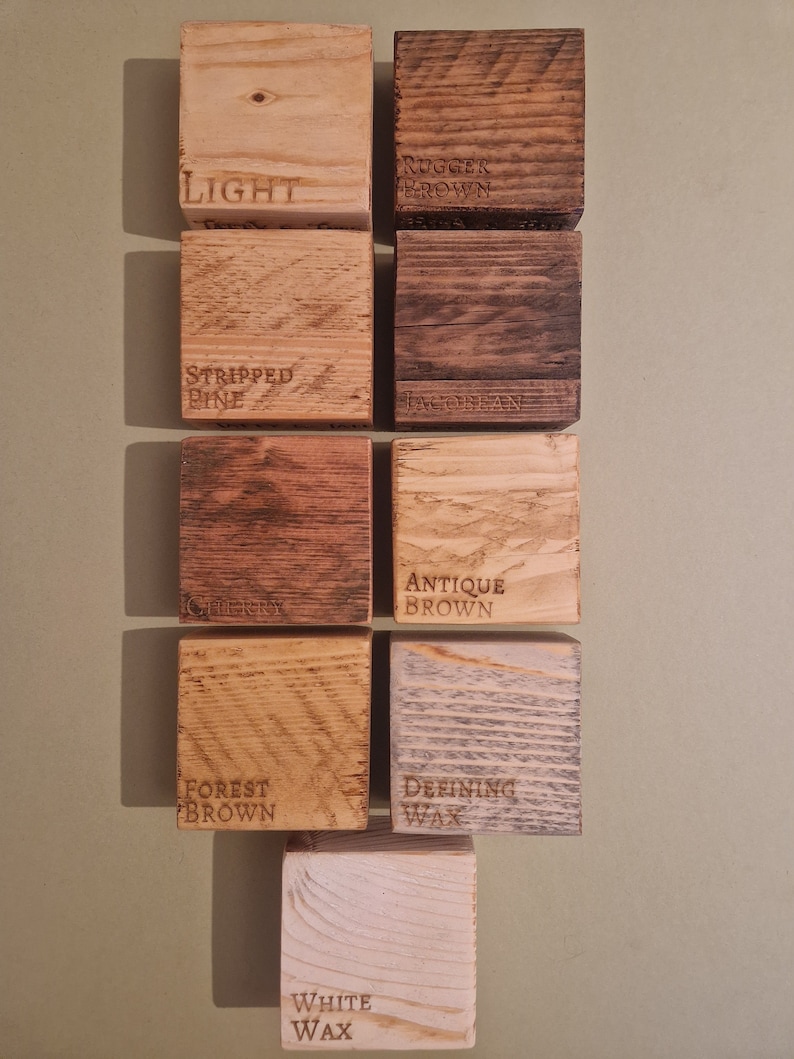 May include: Nine wood samples with different finishes, labeled "Light", "Rugged Brown", "Stripped Pine", "Jacobean", "Cherry", "Antique Brown", "Forest Brown", "Defining Wax", and "White Wax".
