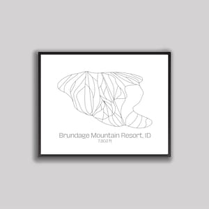 May include: Black framed print featuring a minimalist line drawing of a mountain resort map. The text "Brundage Mountain Resort, ID" and "7,803 ft" are printed below the map. The artwork is set against a white background.