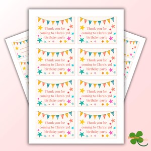 May include: Sheets of party favor tags with the text "Thank you for coming to Clara's 3rd birthday party." Each tag features colorful star and banner illustrations in shades of yellow, teal, pink, and orange.