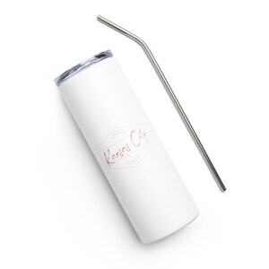 May include: White stainless steel tumbler with a gold and burgundy logo that says "Kansas City". The tumbler comes with a matching stainless steel straw.