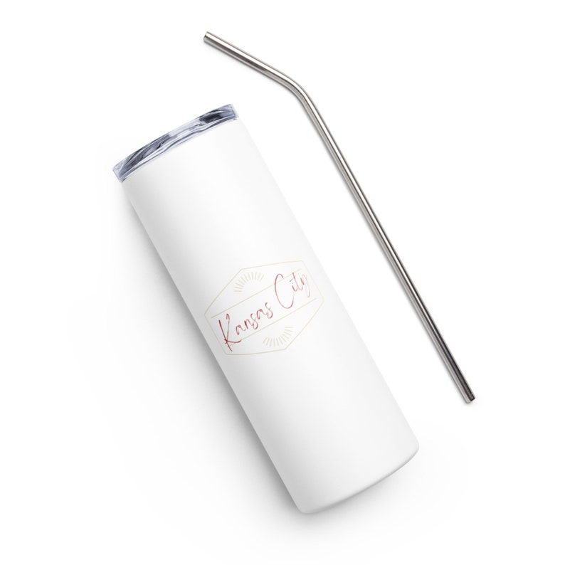 May include: White stainless steel tumbler with a gold and burgundy logo that says "Kansas City". The tumbler comes with a matching stainless steel straw.