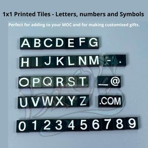 May include: Black and white 1x1 printed tiles with letters, numbers, and symbols. The letters are A through Z, the numbers are 0 through 9, and the symbols are a hyphen, underscore, and the at symbol.