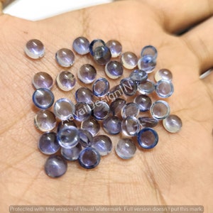 Peut inclure: Une collection de pierres précieuses rondes, translucides et bleues avec un léger éclat iridescent. Les pierres précieuses mesurent environ 6 mm de diamètre et sont idéales pour la fabrication de bijoux.