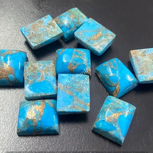 May include: Ten turquoise cabochons with gold flecks. The cabochons are square shaped and have a smooth, polished surface.