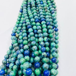 May include: A strand of green and blue gemstone beads. The beads are round and have a mottled appearance.