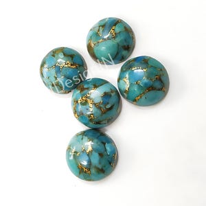 May include: Five turquoise cabochons with gold flecks. The cabochons are round and have a smooth, polished surface.