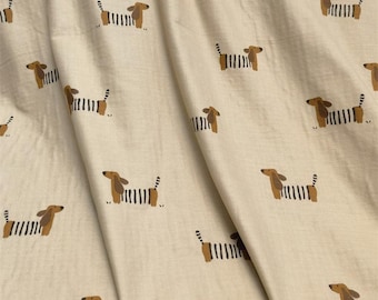 May include: A light beige fabric featuring a repeating pattern of stylized dachshund dogs. Each dog is depicted with a solid brown head and ears, while the body is illustrated with alternating vertical black and white stripes across the torso.