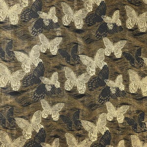 May include: A repeating pattern of butterflies in gold and black on a brown background. The butterflies are detailed with intricate wing patterns, creating a textured effect. The design has a vintage or antique aesthetic.