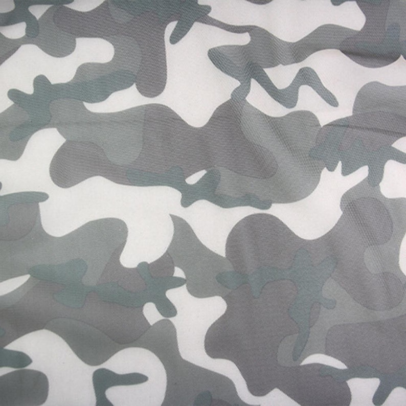 May include: A fabric featuring a camouflage pattern in shades of white, light gray, and dark gray. The design consists of irregular, organic shapes that overlap to create a classic military-inspired motif across the entire surface of the material.