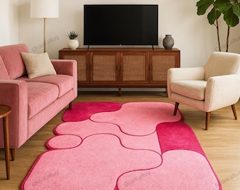 May include: A rectangular area rug featuring an abstract pattern of interlocking organic shapes in varying shades of pink and magenta. The rug has rounded edges and a soft, textured surface, with the text GharKaRug visible in several locations.