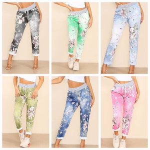 May include: Six pairs of floral print pants with a drawstring waist. The pants are in different colors, including gray, green, blue, light green, blue denim, and pink.