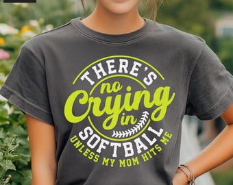 May include: A gray t-shirt with a green and white graphic that says "There's no crying in softball unless my mom hits me."