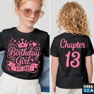 May include: Black t-shirt with pink text and graphics. The front of the shirt says "Birthday Girl EST. 2013" with a crown and hearts. The back says "Chapter 13".