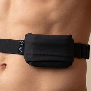 May include: Black waist belt with a small, rectangular pouch. The belt is made of a black elastic material and features a buckle closure. The pouch has a smooth texture and is attached to the belt. The brand name "miqus" is printed on the belt.