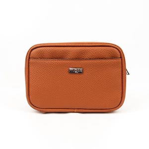 May include: A brown leather zippered pouch with a silver metal logo that says "MIGUS".