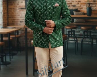 May include: A green patterned jacket with a mandarin collar and a matching pocket square, paired with cream-colored trousers. The jacket features a repeating circular design. The outfit is completed with brown leather shoes.
