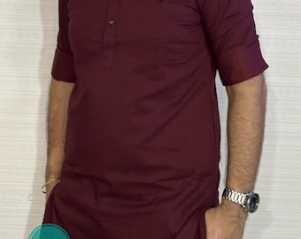 Puede incluir: Una camisa de manga larga de color granate con cuello mandarín y cierre de un solo botón. La camisa tiene un bolsillo en el pecho y un dobladillo largo y fluido. La camisa está hecha de una tela suave y cómoda.