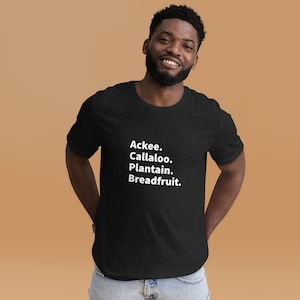 May include: A black t-shirt with white text that reads "Ackee. Callaloo. Plantain. Breadfruit."