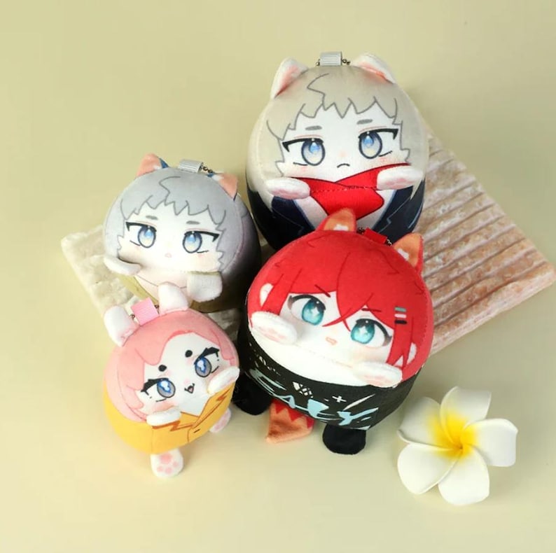 May include: Four plush character dolls with anime-style faces and cat ears. The dolls have different hair colors: gray, red, and pink. The dolls are on a light beige surface with a white flower in the bottom right corner.
