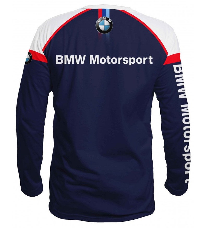May include: A navy blue long-sleeve shirt with white and red accents. The shirt features the BMW Motorsport logo on the back and the BMW logo on the left sleeve. The right sleeve has the text "BMW Motorsport" printed vertically.