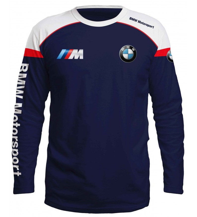 May include: A navy blue long-sleeved shirt with white and red accents. The shirt features the BMW Motorsport logo on the right shoulder and the BMW M logo on the left chest. The words "BMW Motorsport" are printed on the right sleeve.