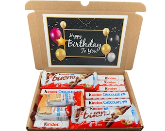 May include: A brown cardboard box with a black and gold birthday card inside. The box is filled with various chocolate bars, including Kinder Bueno, Kinder Chocolate, and Kinder Surprise.
