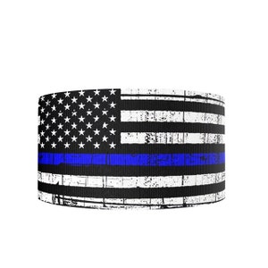 May include: A black and white distressed American flag with a blue line running horizontally across the center. The blue line represents support for law enforcement.