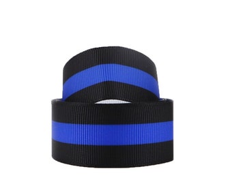 May include: Black and blue ribbon with a thin blue stripe in the center. The ribbon is folded in half.