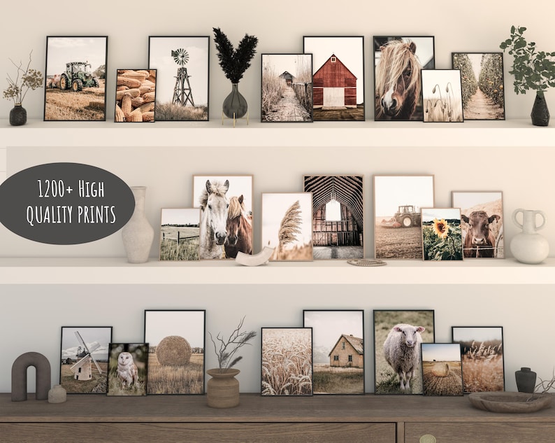 May include: A collection of framed prints featuring various farm and nature scenes, including horses, barns, tractors, and sunflowers. The prints are arranged on a white shelf with a wooden top. The text "1200+ HIGH QUALITY PRINTS" is displayed on a black and white label.
