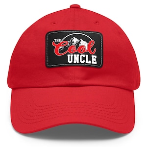 May include: Red baseball cap with a black patch that says "The Cool Uncle" in white and red lettering with a mountain graphic.