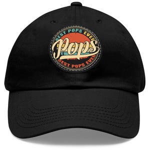 May include: Black baseball cap with a vintage-style circular patch that says "Best Pops Ever" in a colorful font.