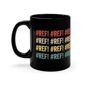 May include: Black ceramic coffee mug with the text "#REF! #REF! #REF! #REF! #REF! #REF!" in a retro rainbow color scheme.