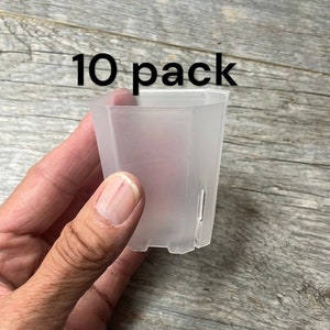 May include: A pack of 10 clear plastic hexagonal plant pots. The pots are translucent and have a slightly textured surface. The text "10 pack" is visible in the image.