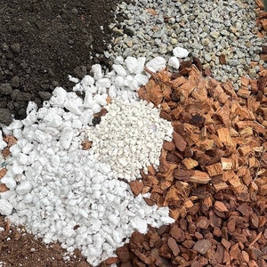 May include: A close-up of four different types of soil: black potting soil, white gravel, white coco chips, and brown coco chips.