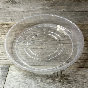 May include: A clear plastic saucer with a raised rim and a 360 degree marking on the bottom.
