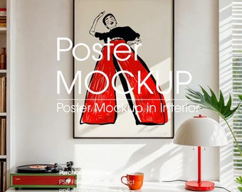 May include: A framed poster mockup featuring a stylized illustration of a person in red pants and a black top. The poster is displayed in a bright interior setting, with a white cabinet, a red and white lamp, and a record player.