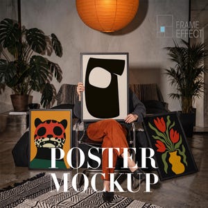 May include: Three framed posters displayed in a room. One poster features a black abstract shape on a cream background, another shows a stylised leopard face in orange, red, and black, and the third depicts red tulips in a yellow vase.