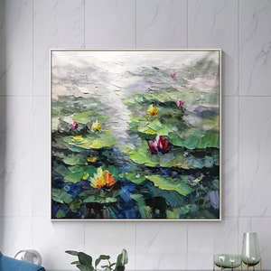 May include: A painting of a pond with water lilies. The lilies are in various shades of pink, yellow, and orange. The leaves are green and the water is a light blue. The painting is done in a loose, impressionistic style.