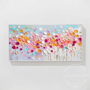 May include: Abstract painting with a textured, colorful floral design. The painting features a variety of pink, orange, yellow, and blue flowers on a light blue background.