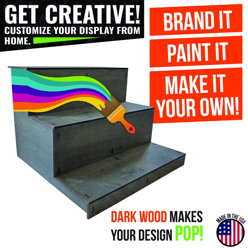 May include: A dark gray, three-tiered display stand with a rainbow paint stroke and a paintbrush. Text reads "Get Creative! Customize Your Display From Home." and "Brand It, Paint It, Make It Your Own!" The stand is made in the USA.