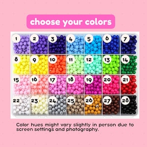 May include: A rectangular plastic organizer box containing twenty-eight compartments filled with small round beads in various solid colors. Each compartment is labeled with a white circular number tag from 1 to 28. Text reads choose your colors.