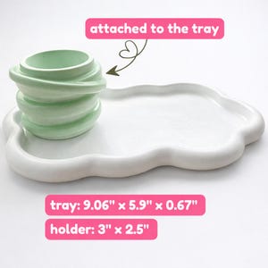 May include: A white cloud-shaped tray with a light green holder attached. The tray measures 9.06" x 5.9" x 0.67", and the holder is 3" x 2.5". The holder has a unique, layered design. The text "attached to the tray" is visible.