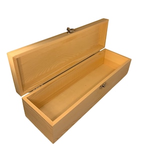 May include: An open, rectangular wooden box with a hinged lid and a metal clasp. The box is made of light-colored wood, possibly pine, and has a simple, clean design. The interior is lined with a light-colored material.